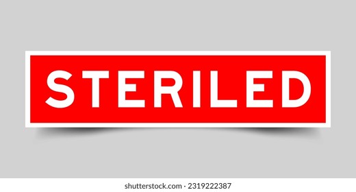 Red color square shape sticker label with word steriled on gray background