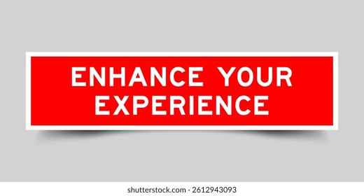 Red color square shape sticker label with word enhance your experience on gray background