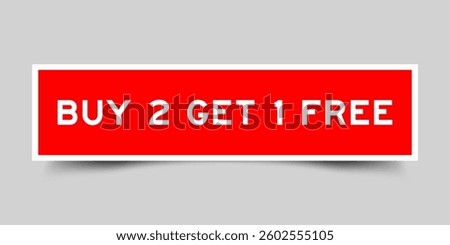 Red color square shape sticker label with word buy 2 get 1 free on gray background