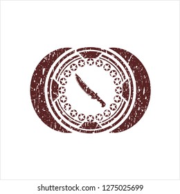 Red combat knife icon inside distressed with rubber seal texture