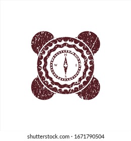 Red compass icon inside distressed grunge stamp