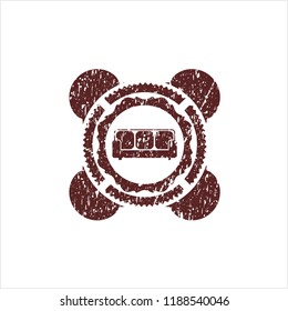 Red couch icon inside distressed rubber seal with grunge texture