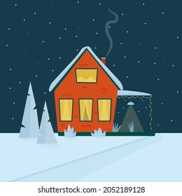 A red cozy house with a roof in the snow with Christmas trees in a snowy courtyard . 