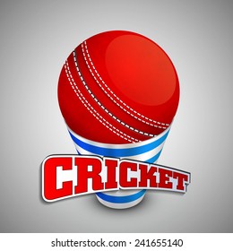 Red cricket ball on a shiny disposable glass with text Cricket on grey background.