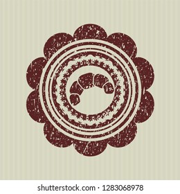Red croissant icon inside rubber grunge seal