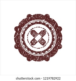 Red crossed bandage plaster icon inside distressed rubber grunge stamp