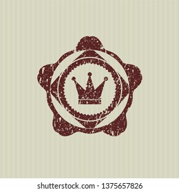 Red crown icon inside distressed rubber grunge stamp
