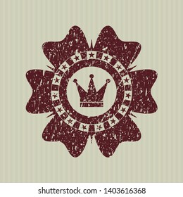 Red crown icon inside distressed rubber stamp with grunge texture