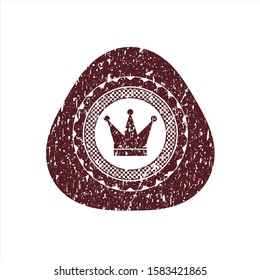 Red crown icon inside rubber seal with grunge texture