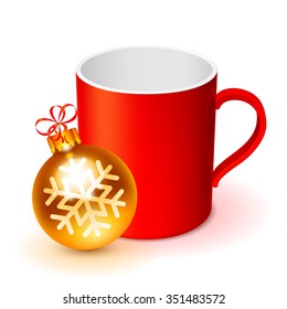 Red cup with golden Christmas ball on white background