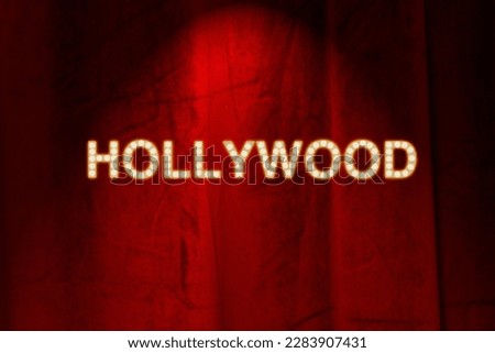 Red curtain with bulb lights, spotlight and Hollywood gold colored lettering. Illustration made April 2nd, 2023, Zurich, Switzerland.