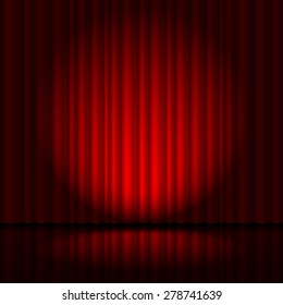 Red curtain from the theatre with a spotlight