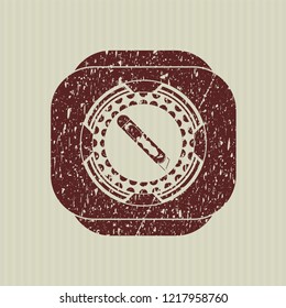 Red cutter icon inside distressed rubber texture