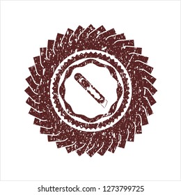 Red cutter icon inside distressed rubber grunge seal
