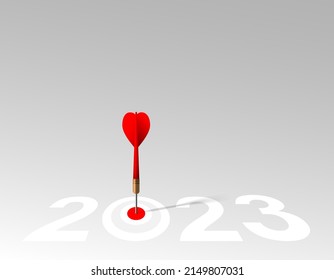 Red dart hit to center of dartboard between number. 2023 New Year with 3d target and goals. Arrow on bullseye in target for new year 2022. Business success, strategy, achievement, purpose concept