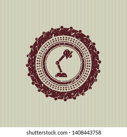 Red desk lamp icon inside distressed rubber stamp with grunge texture