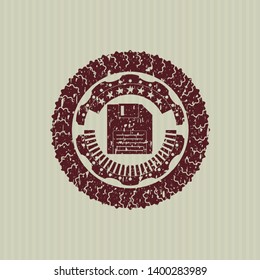 Red diskette icon inside distressed rubber stamp with grunge texture
