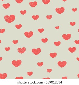 Red distressed hearts of different sizes. Vector seamless background