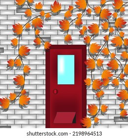Red door with window and pet door with grapes vine with beautiful autumn leaves. Autumn concept with red door in gray building and ivy. Creative autumn picture.  