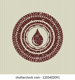 Red drop icon inside distress rubber texture