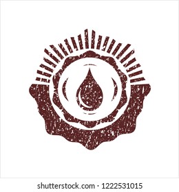 Red drop icon inside rubber texture