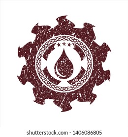 Red drop icon inside rubber grunge texture seal