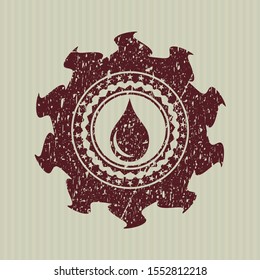 Red drop icon inside rubber grunge stamp