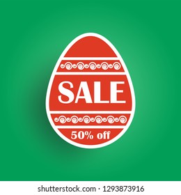 red Easter egg with patterns on green background