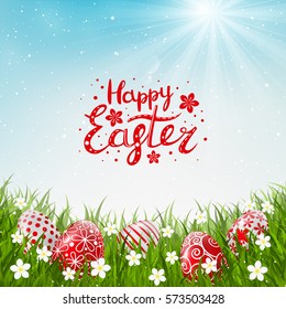 Red Easter eggs on green grass