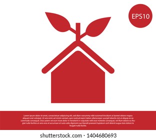 Red Eco friendly house icon isolated on white background. Eco house with leaf. Vector Illustration