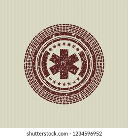 Red emergency cross icon inside rubber grunge texture stamp
