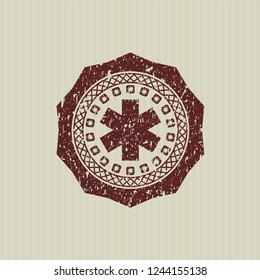 Red emergency cross icon inside grunge stamp