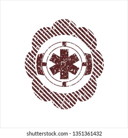 Red emergency cross icon inside distressed with rubber seal texture