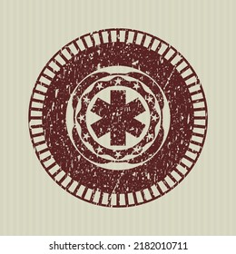 Red emergency cross icon inside distressed grunge stamp. 