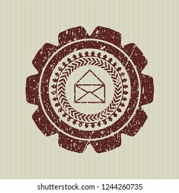Red envelope icon inside distressed rubber seal with grunge texture