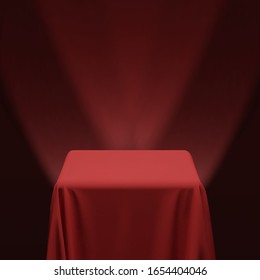 Red fabric covering a cube or a table, with red background and stage spotlights. Can be used as a stand for product display, draped table. Vector illustration