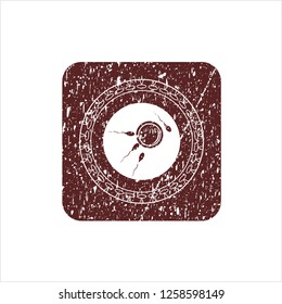Red fertilization icon inside distressed rubber texture