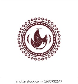 Red fire icon inside distressed rubber grunge seal