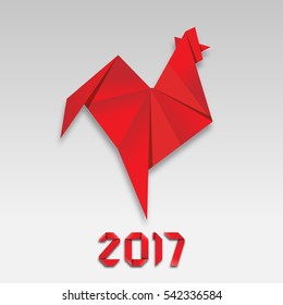 Red fire paper folded rooster handmade origami. holiday greeting card. Happy new year 2017