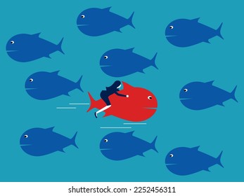 The red fish swims in the opposite direction from the other fish. Courage and confidence. business difference