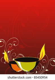 red floral pattern background with lit lamp for deepawali celebration & other indian festival