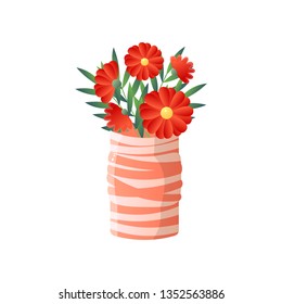 Red flowers in striped vase isolated on white background