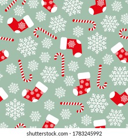 Red fluffy Christmas stockings, candy canes and white snowflakes on green background seamless pattern. Vector Christmas gift socks. Flat vector Illustration. Simple design for web and print