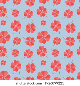 Red four leaf clovers on blue background. Trendy vector pattern made of four leaf clovers. Seamless design for banner, card, wallpapers and wrapping. 