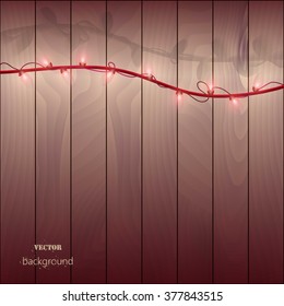 red  garland with light bulbs on a wooden background. Vector bulb with a wire and wooden boards, lighting