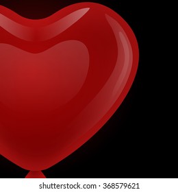 Red gel floating balloon in the shape of heart looks to the left on a black background.