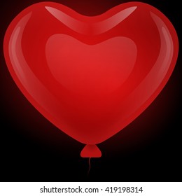 Red gel floating balloon in the shape of a heart on a black background.