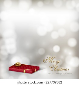 Red gift on the gray christmas background. Vector design elements.