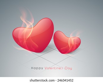 Red glossy hearts in flame for Valentine's Day on shiny grey background.