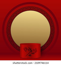 Red, gold and black showcase, with a Chinese atmosphere, with a podium in the foreground, decorated with a branch of bamboo, to display a commercial product and a circle pattern in the background. 